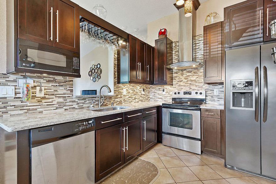 Welcome home to the historic Vedado! True 3 bedrooms, 2 full baths and beautifully upgraded, well maintained and boasting superb features throughout; 42'' walnut kitchen cabinets, stainless steel appliances, quartz counters, stone and glass backsplash, deep stainless steel sink, stainless steel stove stack to roof, built in wine rack, under mount lighting, hi end stainless steel hardware and pantry. Walking through you will discover; 10 foot vaulted ceiling's, knock down walls and ceiling's, plant shelves, neutral ceramic tile throughout common areas and real wood floors. Baths feature gorgeous travertine floors, walls and showers and tastefully done vanities. Stepping into the spacious master suite brings you to 10' vaulted ceiling's, 6 x 10 walk-in closet and (click more) glass doors that overlook the trellis covered 16 x 10 back patio and private fenced backyard. Stepping outside you will feel like you entered a tropical oasis with palms galore, custom concrete landscaping borders, mature foxtail palms, Eureka palms, silver Bismarck, Christmas palm, screw pine, ponytail, bottle palm, coral and rock accents, 14 x 16 trellis covered side porch off the family room. Additional fantastic features include a convenient four car driveway, 8 x 15 front porch, QC infrared camera system and 7 x 7 shed on concrete slab. It gets even better, hello homeowners insurance savings... brand new roof with transferable warranty, CBS construction, hurricane impact windows and sliders have hurricane shutters. Even the partially converted garage has great features; 1 car garage, epoxy floor, built in shelves and workbench, pulldown stairs, extra 7 x 14 storage area and under central air or mini split system 7 x 13 office (or space for whatever your heart desires) if one prefers space could be easily converted back to a two car garage. Vedado Park is located in a quiet quaint neighborhood. Which offers a community center, playground, swings, T-ball field, basketball court, tennis court and offers some fine picnic spots. The community center is home to a wonderful after school program and summer camp. Superbly located just minutes to everything one could possibly desire and home to fine shopping and dining, arts and culture, entertainment, marinas, waterfront parks and blueways, business and economic development, education, green living, miles of scenic pedestrian pathways for walking, biking, jogging, convenient travel, world class beaches, boating, fishing, golf and so much more!