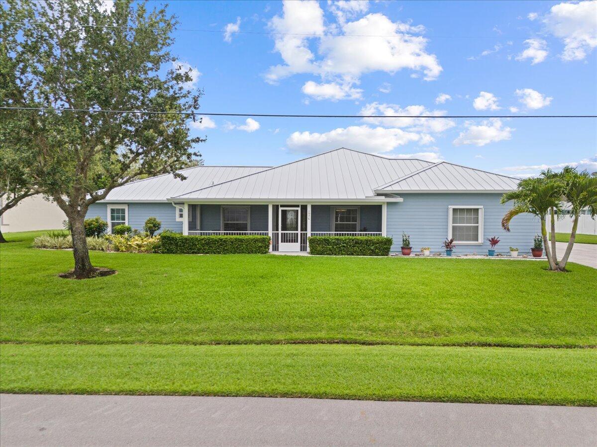Exceptional Home on double lot with canal setting offers stunning well maintained home in PSL. Features Polysteel finished Walls, concrete construction & Hardie board siding. New Metal Roof, gutters, downspouts in 2024, gorgeous new porcelain tile flooring throughout, fresh paint, Full Home generator, New Gas Range, washing machine, gas dryer, electric & solar hot water heater. Offers 4 BR's, 3 BA's, 2.5 side load garages, extended concrete driveway, charming front screened enclosed patio & spacious screen enclosed lanai with LG yard, tranquil setting & plenty of room for a pool. This home is Handicap accessible throughout. Safe Room included & could be used for anything you need. Play area, storage or Flex Room. Large Laundry RM with storage. Build Smart FPL Certified Energy Efficiency.