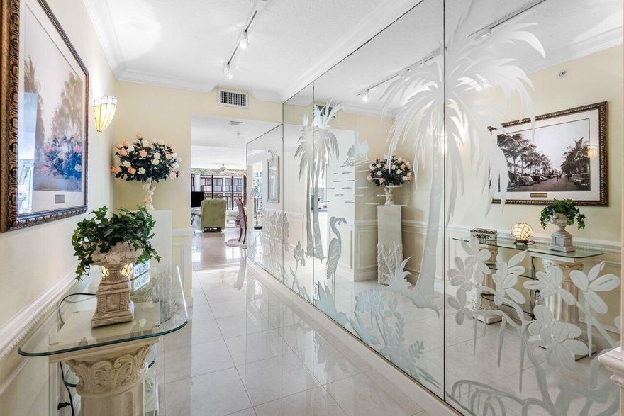 This elegant residence, says ''Palm Beach,'' and greets you with breathtaking views of the sunrise to sunset. Nestled on the 5th floor of the Halcyon's North Building, this spacious two-bedroom, two-bathroom floor plan boasts two glass balconies that offer stunning Southeast Ocean views and panoramic vistas of the Intracoastal. Step inside and you'll be enveloped in a meticulously maintained property. Hurricane-impact doors and glass ensure the safety, while a custom eat-in kitchen, a custom bar with beautiful back-lit etched accent glass, wainscoting walls, custom cabinetry, and attractive stonework add to the home's charm. The Halcyon, where this residence resides, offers a range of amenities to enhance your stay. Enjoy the convenience of 24/7 doormen, a resort-style pool area and beach,