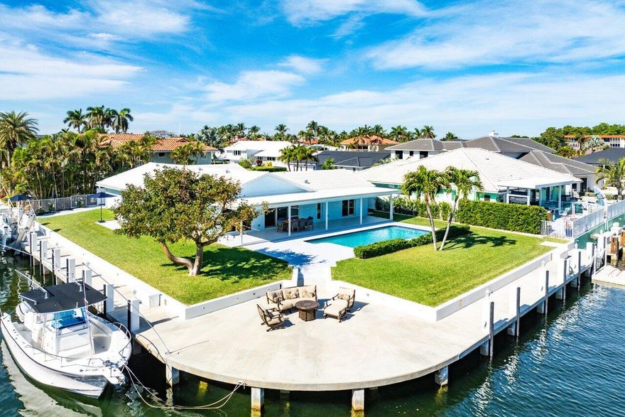 Live the Florida Lifestyle in this Waterfront Boater's Dream Home! Rare SE Deepwater Point Lot boasts 211 feet of Waterfrontage with Intracoastal and Canal Views. Ocean access with no fixed bridges. Upon entering this exquisite 3 bedroom, 2.5-bath-home, you are captivated by the sparkling water views and wide-open space. Completely renovated including new kitchen, baths, flooring, plumbing, insulation, wiring, 5-ton AC unit with new duct work and impact windows and doors. New roof in 2021 with trusses secured to concrete headers with solid steel Simpson plates for additional hurricane protection. Stunning gourmet kitchen features custom cabinetry, large stone cook island and Thermador appliances with double wall ovens. The owner's suite includes a generous walk-in closet, additional built-in cabinetry and an inviting bath with rainfall shower. Relax around your heated saltwater pool and expansive deck oasis, ideal for entertaining while overlooking the sparkling waterway. There is also an outdoor hot/cold shower for convenience after a long day on the boat. New sea wall, batter piles as well as solid concrete wrap around dock which had been raised 18 inches to meet current elevation requirements. 20,000 lb. cradle boat lift with two high-speed motors and an Armor Wave port jet ski dock. The wrap around dock offers ample water, electricity, cleats and whips for multiple boats as well as fiberglass storage boxes and a 6 ft. filet station. Coral Key Villas is one of South Florida's prime waterfront communities located close to the Hillsboro Inlet, Lighthouse Point Yacht Club, marina, upscale shopping and restaurants.     All information published and provided including but not limited to measurements, features, finishes, taxes, etc., are subject to errors and omissions. All such information should be independently verified by all parties who should perform their own due diligence to verify all information. The listing company expressly disclaims any warranty or representation regarding such information.