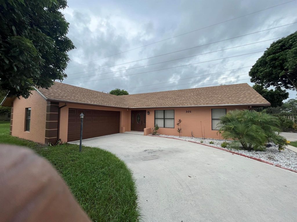 Photo of 301 W Canterbury Drive W, Riviera Beach, FL 33407 (MLS # R11032538)