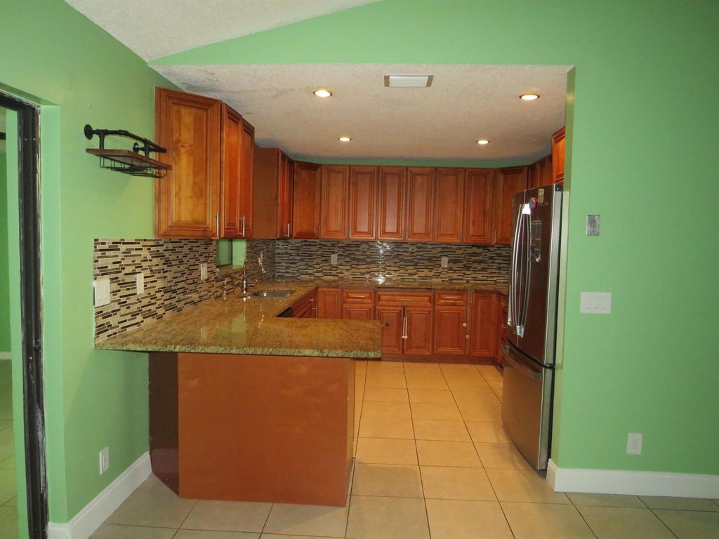 Photo of 301 W Canterbury Drive W, Riviera Beach, FL 33407 (MLS # R11032538)