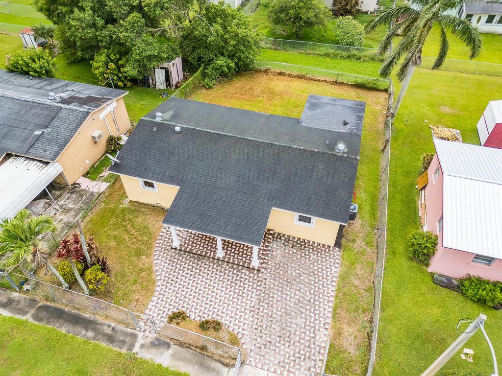 Photo of 1528 Singletary Avenue, Pahokee, FL 33476 (MLS # R11095936)