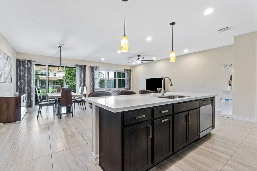 Spectacular! This stunningly updated 3-bedroom + loft/den/office, 2.5 bath and 2-car garage home has it all! This 2018 luxury townhouse has barely been lived in. You will fall in love with the large open floor plan, chef's dream kitchen featuring a large quartz countertop island, state of the art appliances, morning bar & custom built-in pantry. Tons of natural light & entertaining space with a screened-in patio and fenced-in backyard. Porcelain tiles span the entire main level and a luxury vinyl flooring is installed throughout the second level of the home. Large bedrooms with high ceilings and built-in custom California Closets are in every room, with a Master Bedroom closet that is to die for! Hurricane impact windows and sliding glass doors throughout. Plantation shutters add to