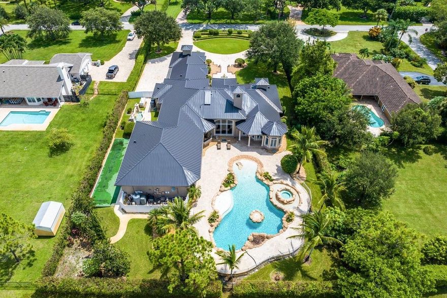 Gold Standard in Luxury & Privacy! Exceptional finishes, the finest craftsmanship, meticulous millwork & soaring vaulted groin coffered ceilings perfectly blend to create a sophisticated & special estate. Walls of impact glass welcome in soft natural light, views of the glorious pool & beautiful outdoor spaces throughout. A white onyx fireplace & stunning light fixtures take centerstage in the commanding foyer/living room. The Kitchen/Family Room is impressive in size & offers a crisp white island kitchen with custom cabinetry, thick white stone counters, top shelf appliances etc. Other Offerings:5 star resort worthy primary suite/theater/wine closet/gym/steam room/huge jaw dropping pool/large screened porch with fireplace/most bedrooms with ensuite bath/whole house generator/2022 ROOF