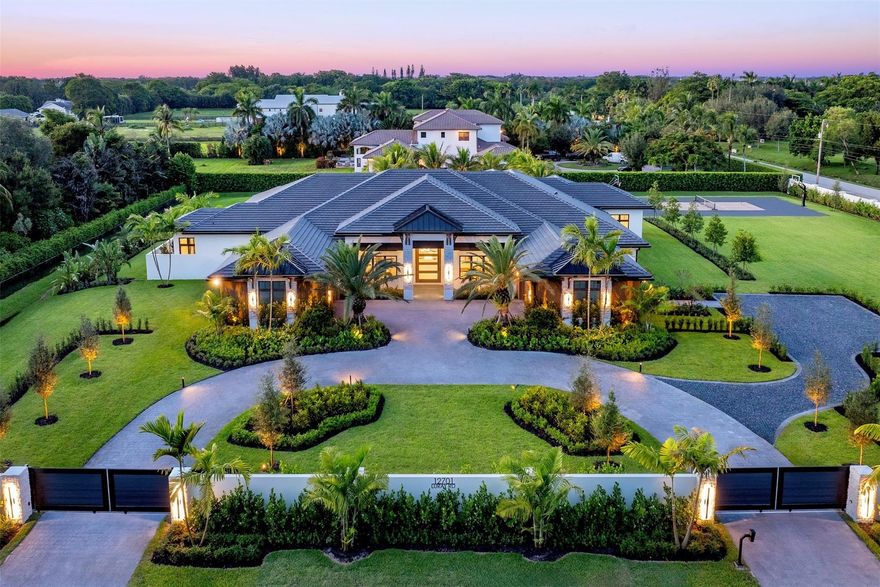 Luxury meets lifestyle at this Southwest Ranches Gem! This COMPLETED design-inspired estate offers +-10,000 SF of Indoor/Outdoor living space & sits on more than 2 acres. A true compound featuring privacy wall, automated gated entrances and 4 car garage. The interior features 5 spacious bedrooms, dedicated library/office, gym, club room, & 6.5 baths. Open-concept layout anchored by an iconic fireplace. The chef’s kitchen is a showstopper with Wolf appliances, 60” gas range, Cristallo countertops, & expansive prep and storage area. Cool off in your resort-style heated pool, raised spa, swim-up bar, & a fully equipped outdoor kitchen and enjoy a newly built basketball and pickleball court surrounded by lush landscaping. Southwest Ranches is the crown jewel of Broward County. Move in READY!