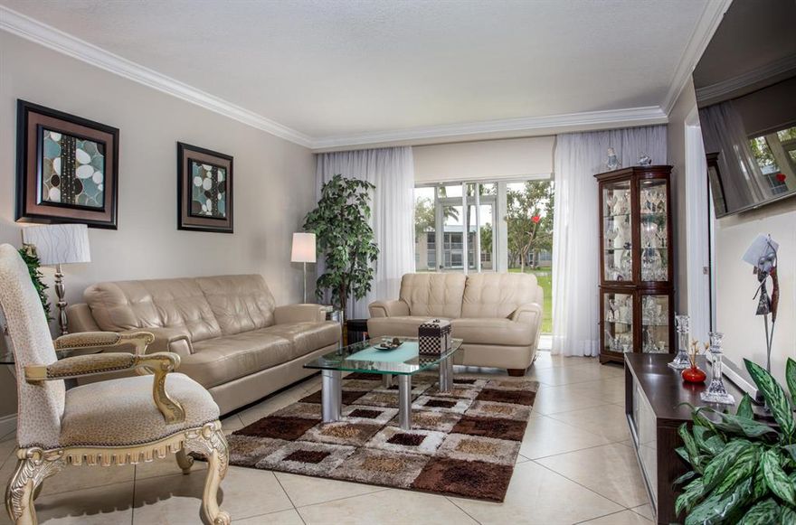 Beautiful 2/2 condo on the ground floor. Completely re-done  custom wood Kitchen Cabinet's with top of the line appliances including a double wall oven, granite counter tops, crown molding through-out. Custom window treatments. All new Hurricane impact windows and front door
Owner is a licensed Agent