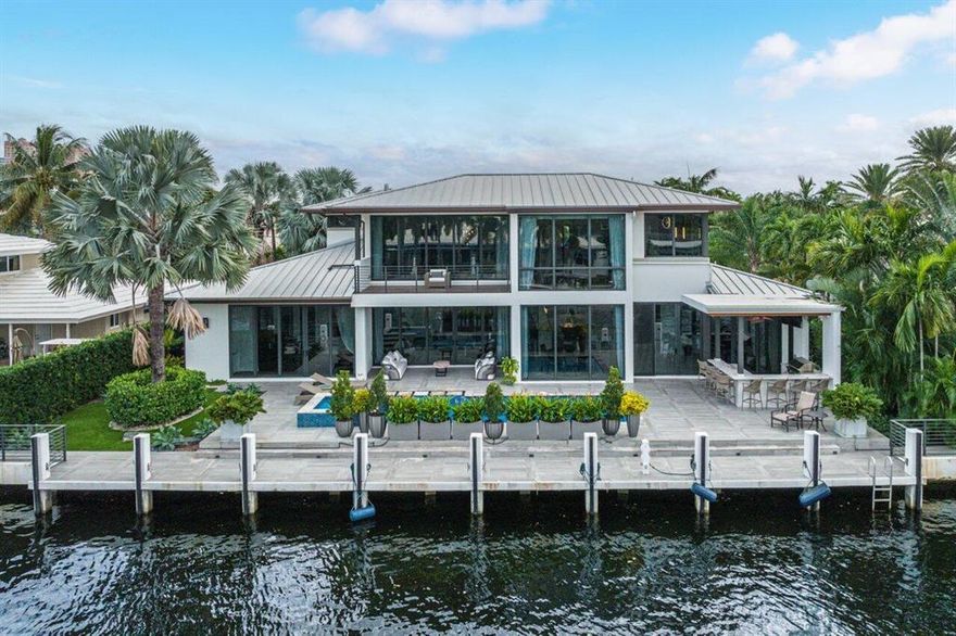 Modern and sophisticated perfectly describe this waterfront home. Built in 2015, this newer residence is the perfect blend of contemporary finishes, sleek design and inviting atmosphere. Entering the home, a tranquil exterior waterfall feature sets the tone of the custom estate. The two-story foyer immediately impresses with 22 foot tall walls of glass captivating your attention ahead. The great room acts as the heart of the home featuring a floor-to-ceiling stone stacked fireplace, large sliding doors leading outside, and full connectivity to the rest of the open concept living areas. Eyes are drawn to the custom temperature controlled wine room which can hold 230 bottles of your perfect vintage. A true gourmet kitchen, chefs can delight using the top-of-the-line appliances including a