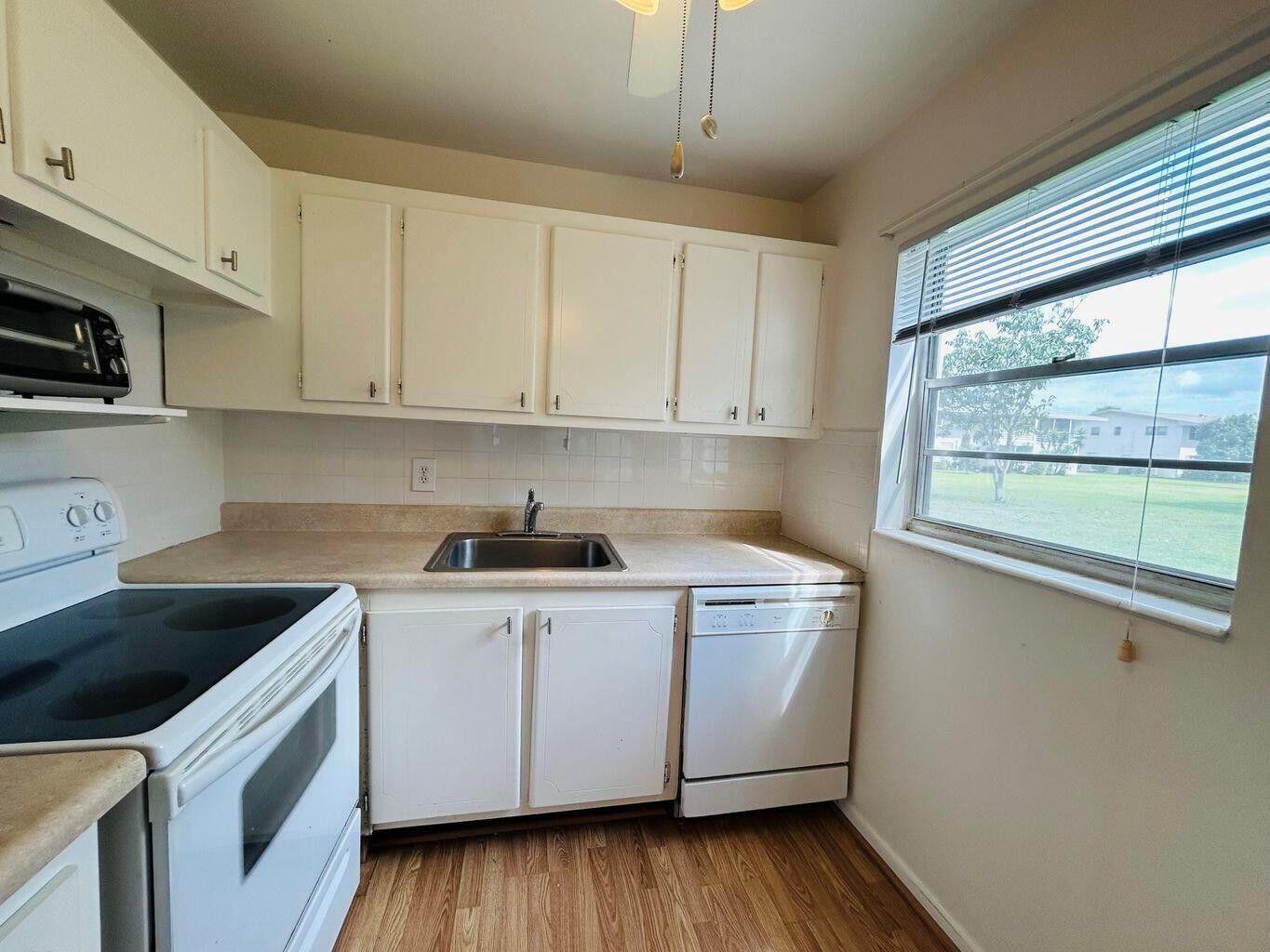LOCATION! LOCATION! RARE GROUND FLOOR CORNER 2BED 1.5 BATH CLOSE TO THE CLUBHOUSE & HAVERHILL GATE.MOVE IN READY. PARTIALLY FURNISHED, WHITE KITCHEN WITH DISHWASHER. CENTRAL AIR, HURRICANE SHUTTERS. LANAI HAS A DOOR TO GO OUT AND ENJOY THE OUTDOORS. ENJOY RESORT STYLE LIVING IN THIS GATED COMMUNITY FOR ACTIVE ADULTS 55+ . WELL MANAGED ASSOCIATION.Roomy closets (one walk-in),laundry room, assigned parking spot plus visitor parking available; local bus for errands/shopping both within & outside The Village; . Clubhouse with theater, shows, movies, craft and card rooms, billiards, aerobics, yoga, and dance classes. GREAT LOCATION: close to shops, restaurants, PB