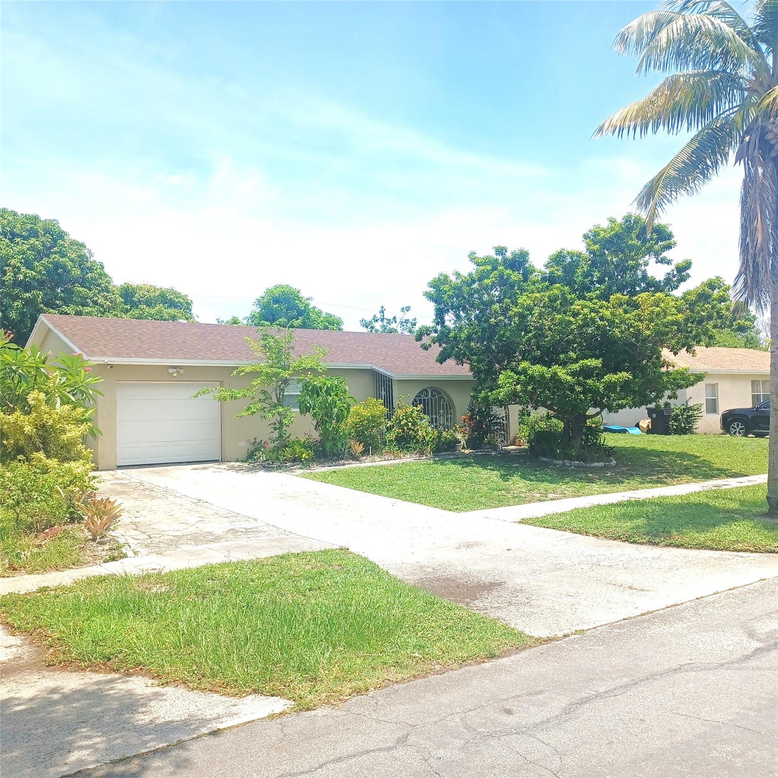 Renovated 3 Bedrooms 2 Bathrooms 1 Car Garage Plus A Huge Permitted Converted Rear Patio and Rear Outside Storage Room. This Home Boasts New Roof, New A/C, Newer Tiled Floor, Updated Kitchen, New Stainless Steel Kitchen Appliances, Oversized Backyard with Fruit Trees, Such As Star Fruit, Multiple Mango Trees, Soursop, Coconut, and Ackee. Come Home to This Beauty Located 2 Minutes from I-95, a Few Minutes from the Beach, Port of Palm Beach, Florida Turnpike, Major Shopping and Restaurants