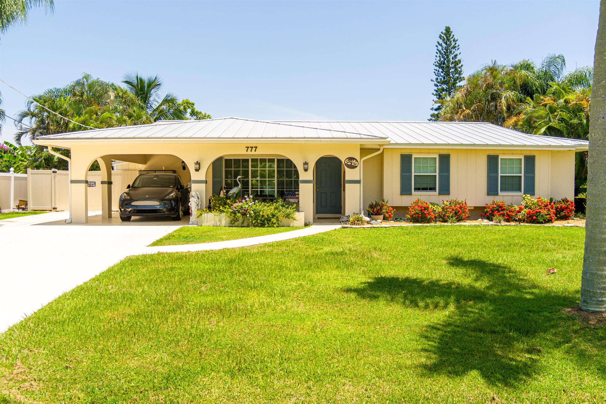 Boater's Paradise with Ocean Access. Nestled on a deep-water canal just minutes to the St. Lucie River, this CBS 3BR/2BA pool home is the ultimate Florida retreat. Enjoy the charm and character throughout--from the beautifully remodeled kitchen and master bath to the inviting living spaces filled with natural light. The fully screened outdoor oasis features a enclosed pool & hot tub, surrounded by a lush privacy hedge and fenced yard--perfect for pets, kids, and entertaining. Metal roof (2020), AC & water heater (2019), dock with electric and boat lift. Home is wired for and includes gas generator and a Tesla electric charging station. Partial impact windows. Safe anchorage during storms. No HOA. This home offers the ideal blend of fun, function, and laid back coastal style.