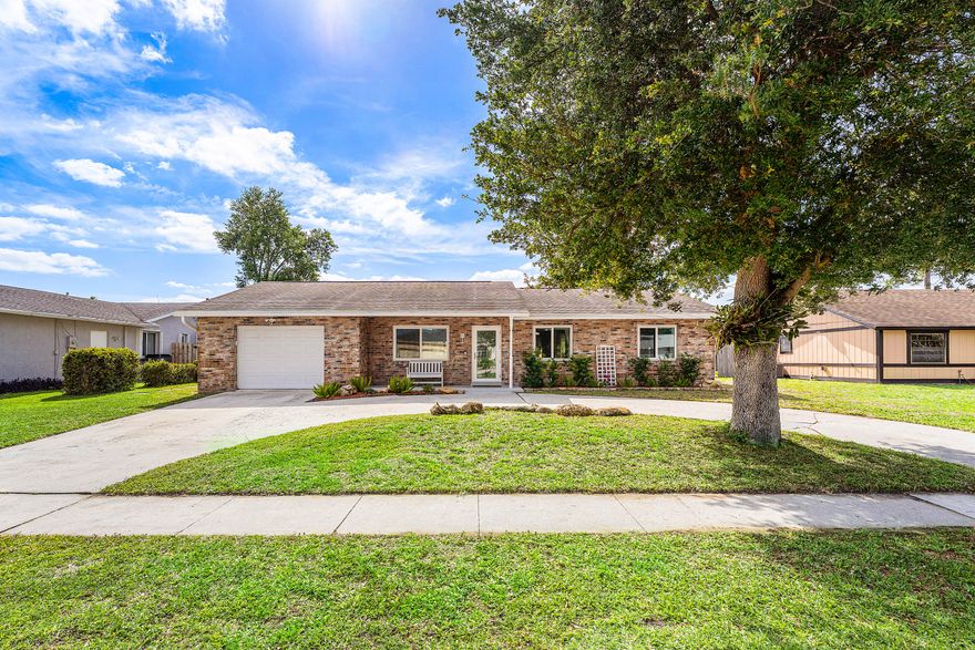 Well-maintained 3BR/2BA/1CG pool home in La Mancha with a 2019 roof! This brick-front residence features an updated kitchen with Corian countertops, wood cabinetry, newer appliances, built-in desk, and pass-through to the patio—perfect for entertaining. Spacious primary suite with updated bath and beautifully retiled shower. Guest bath offers a jetted tub with new motor and updated vanity. Entire home retiled approx. 4 years ago. Enjoy a screened patio overlooking a private pool and large fenced yard, plus plumbing for a future summer kitchen. Hurricane-impact windows and doors throughout. Circular driveway, double gate for boat/RV, generator hookup, and pool resurfaced less than 1 year ago. Close to parks, schools, shopping, and highways!