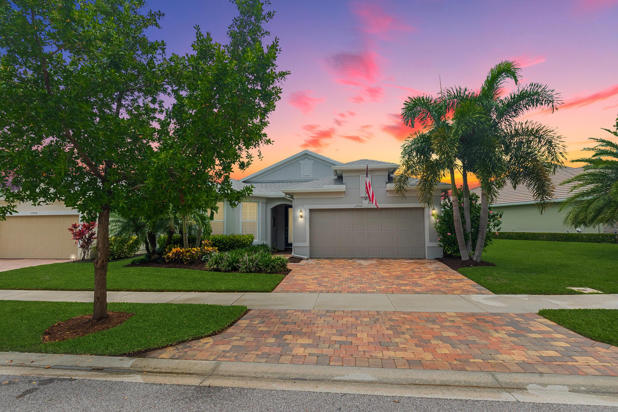 Welcome to this stunning 3-bed, 2-bath home in the sought-after Del Webb 55+ community located in Tradition! Nestled on an oversized lot with tranquil preserve views, this home offers the perfect blend of comfort and style. The gourmet kitchen boasts quartz countertops, 42'' cabinets, gas cooking, and a spacious island for entertaining. Relax in the extended screened lanai and enjoy peaceful outdoor living. Impact glass windows provide added peace of mind. The luxurious primary suite features a walk-in shower and custom shelving in the master closet. Oversized 2-car garage. Resort-style amenities await - 2 clubhouses, 2 pools, fitness centers, a putting green & more -- Don't miss this one!