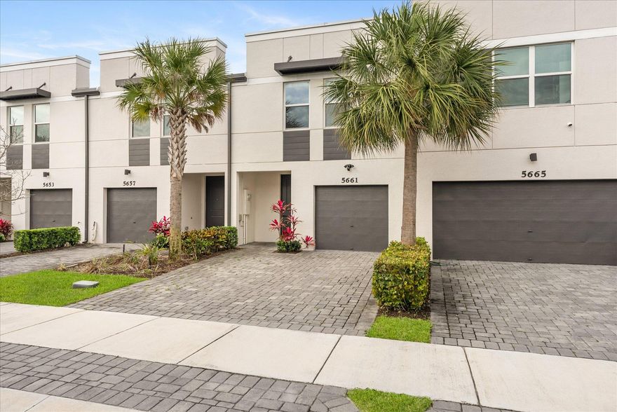 Wake up to serene lake views every morning from this freshly painted, move-in-ready 3-bedroom, 2.5-bath townhome in the gated Enclave at Mangonia Park. Built in 2022, this beautifully maintained residence offers 1,454 square feet of thoughtfully designed living space with brand new flooring, impact windows, all-block construction, 1-car attached garage and enlarged paver driveway.  Inside, the bright and open-concept floor plan creates the perfect setting for both everyday living and entertaining. The spacious kitchen with quartz countertops overlooks the living and dining areas, making it easy to stay connected with family and guests. Upstairs, a versatile loft area offers endless possibilities and can easily serve as a home office, media room, playroom, or additional lounge space. This home feels practically new, with nearly new appliances, energy-efficient construction, and low utility costs adding even more value. The freshly painted interior and updated new flooring give the home a clean, modern feel that is truly move-in ready from day one.  What truly sets this property apart is its premium lakefront location. Few homes in the community offer such peaceful water views, creating a relaxing backdrop for your morning coffee or evening unwind. Whether enjoying the scenery from inside the home or the outdoor area, the lake view adds a sense of privacy and tranquility that is hard to find.  Residents of the Enclave at Mangonia Park enjoy a gated entrance, community pool, and a convenient location just minutes from I-95, Downtown West Palm Beach, Palm Beach International Airport, shopping, dining, beaches, and major medical centers.  This home is ideal for first-time buyers, seasonal residents, professionals, or anyone looking for a low-maintenance lifestyle in a newer construction community. Ask about available Palm Beach County down payment assistance programs that may help significantly reduce your out-of-pocket costs.