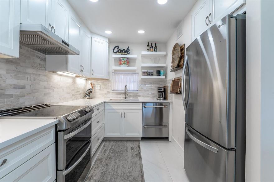 TOTALLY UPGRADED! 2BR/2BA BRIGHT CORNER w/ SPECTACULAR PGA GOLF VIEW ON 10TH FAIRWAY. Open kitchen features high ceiling w/LED lighting, SS appliances (with double door dishwasher, under counter microwave), new electric panel, extra pull-out pantry, quartz counters & island & full tile backsplash. Special 48" ceramic tiles throughout. 2 showers. Washer/Dryer Combo. Tankless HTWH. Fully Furnished. Recreation Lease PAID IN FULL! Amenities include Restaurant, Billiard Room, Bbq/Picnic Area, Clubhouse, Courtesy Bus, Exercise Room, Heated Pool, Library, Putting Green, Sauna, Shuffleboard, Tennis, Pickle Ball, Vehicle Wash Area, Electric Car Charging Station. Close to shopping, dining, highways, International Airports, and top rated medical facilities. 15 min. to the beach. FIRST CLASS! LOVE IT!