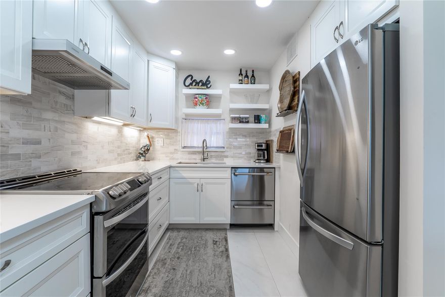 TOTALLY UPGRADED! 2BR/2BA BRIGHT CORNER w/ SPECTACULAR PGA GOLF VIEW ON 10TH FAIRWAY. Open kitchen features high ceiling w/LED lighting, SS appliances (with double door dishwasher, under counter microwave), new electric panel, extra pull-out pantry, quartz counters & island & full tile backsplash. Special 48" ceramic tiles throughout. 2 showers. Washer/Dryer Combo. Tankless HTWH. Fully Furnished. Recreation Lease PAID IN FULL! Amenities include Restaurant, Billiard Room, Bbq/Picnic Area, Clubhouse, Courtesy Bus, Exercise Room, Heated Pool, Library, Putting Green, Sauna, Shuffleboard, Tennis, Pickle Ball, Vehicle Wash Area, Electric Car Charging Station. Close to shopping, dining, highways, International Airports, and top rated medical facilities. 15 min. to the beach. FIRST CLASS! LOVE IT!