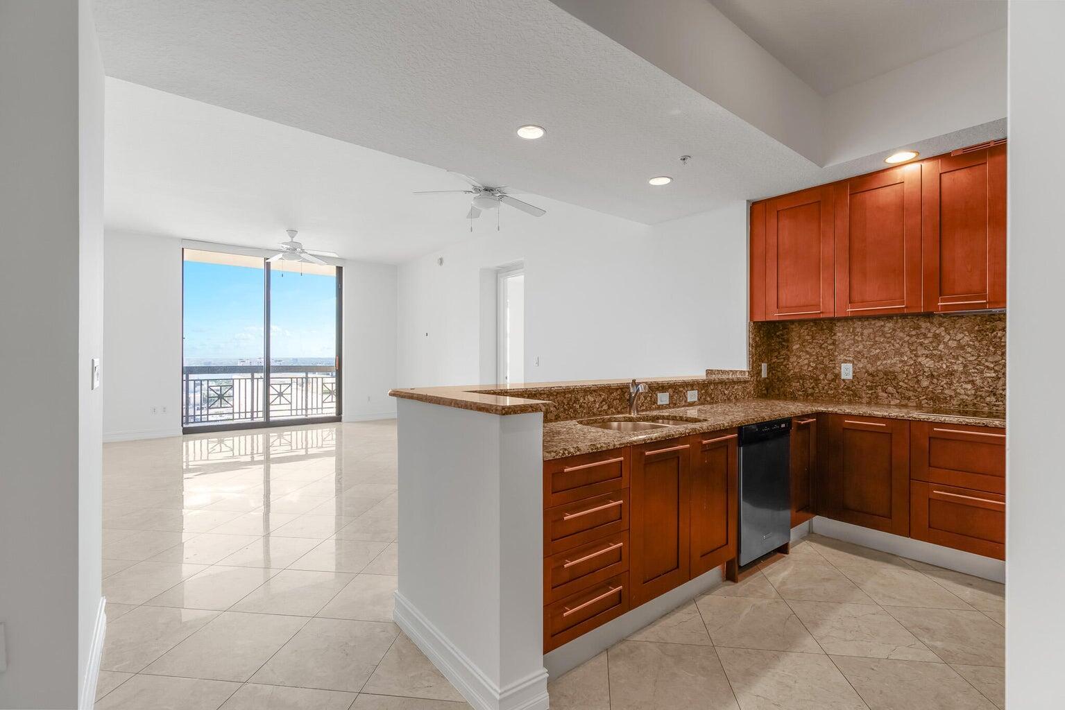 Experience the Ultimate in Luxury Living at Two City Plaza in Downtown West Palm Beach Indulge in the luxurious lifestyle at Two City Plaza, located in the heart of downtown West Palm Beach. This exquisite condo, situated on the 16th floor, boasts a generous 1483 square feet of living space, including two bedrooms, two bathrooms, and a den. Enjoy breathtaking western views with stunning sunsets and natural light streaming through the large windows. The vaulted ceilings and marble flooring in the living room and kitchen add a touch of opulence to this already lavish space. The building offers an array of first-class amenities, including a massive rooftop pool with breathtaking views in every direction, a top-of-the-line gym, theater, and a beautiful lobby with friendly staff.Take adva
