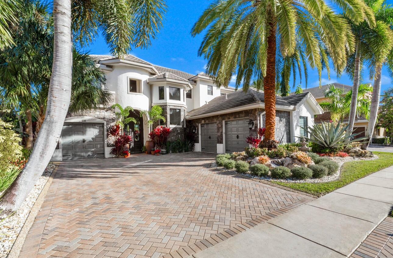 Exceptional waterfront home offering expansive lake views and premium upgrades throughout. This beautifully maintained residence features brand-new hurricane impact windows and doors, including a striking 12-foot, 600 lb iron and impact glass front door that makes a castle-like entrance statement. Enjoy peace of mind with a new whole-house generator, reverse osmosis water treatment system, and whole-house water softener. The backyard is an entertainer's dream with a heated gunite saltwater pool and spa (with new pump), fully equipped outdoor kitchen, and new professional landscaping and hardscaping that elevate the outdoor living experience.