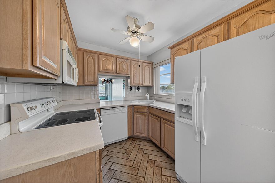 2 Bed/2 Bath corner unit steps to the pool with lake & pool views in the 55+ active adult community of Bermuda Club in Tamarac! Great opportunity to make this unit your own with tons of natural light, walk-in closets in both bedrooms, and over 1,000 square feet of living space. Master Bedroom features an ensuite bathroom w/oversized shower and space for a dual sinks. Kitchen & entryway features porcelain tile floors. Enjoy an enclosed patio overlooking the lake and pool. Community amenities include 4 pools, tennis courts, mini golf, and a clubhouse with a library, ballroom, updated fitness center & movie theater. HOA covers cable, reserve funding, exterior insurance and pest control. Conveniently located near major transportation, bus routes, shopping centers, restaurants, and more!