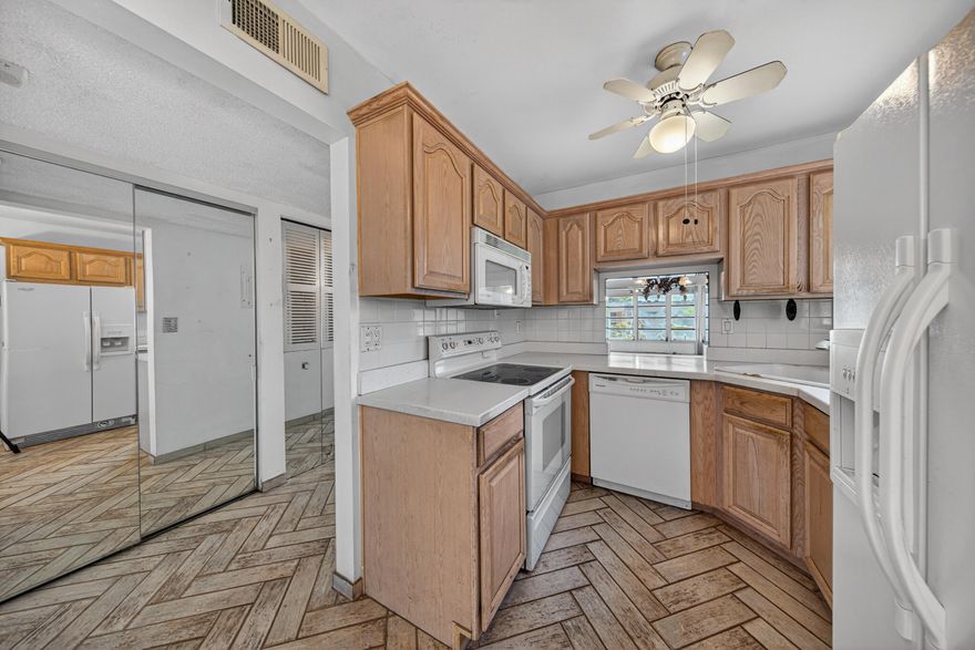 2 Bed/2 Bath corner unit steps to the pool with lake & pool views in the 55+ active adult community of Bermuda Club in Tamarac! Great opportunity to make this unit your own with tons of natural light, walk-in closets in both bedrooms, and over 1,000 square feet of living space. Master Bedroom features an ensuite bathroom w/oversized shower and space for a dual sinks. Kitchen & entryway features porcelain tile floors. Enjoy an enclosed patio overlooking the lake and pool. Community amenities include 4 pools, tennis courts, mini golf, and a clubhouse with a library, ballroom, updated fitness center & movie theater. HOA covers cable, reserve funding, exterior insurance and pest control. Conveniently located near major transportation, bus routes, shopping centers, restaurants, and more!