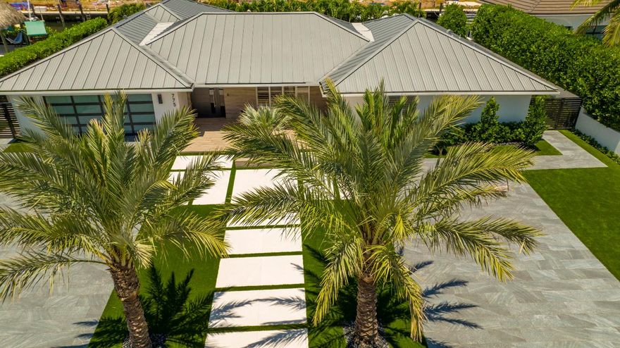 Situated on a quiet cul-de-sac, this virtually maintenance free residence features Italian-imported-porcelain pavered driveways flanking a dramatically lit entry walkway. The front yard is beautifully landscaped with Medjool date palms, Beccariophoenix Alfredii palms, a lush Garcinia tree all surrounded by Highlander artificial turf and black landscape stones. Back yard also features artificial turf and black landscape stones.  An expansive covered loggia with electric vertical screens overlooks the 50-foot salt-water lap pool, with a sunshelf and overflow-spa, and large patio. Perfect for outdoor entertaining is a composite slate-gray summer kitchen with imported LAPITEC waterfall countertop,  36-inch Heston natural-gas grill perfect for yachting enthusiasts is a new 70'x7' concrete dock. A luxurious waterfront oasis for South Florida indoor/outdoor lifestyle at its finest and completely renovated from top to bottom in 2022, this reimagined casually elegant modern residence lives like brand new custom construction. Furnished to be a designer-finished showplace, with three bedrooms and 3,568± total square feet, its open-floor-plan layout is oriented to accommodate pool views from floor-to-ceiling glass sliding doors that bring the outside in. Other embellishments are handsome custom millwork, large-format Italian-imported ceramic tile flooring, Italian-imported lighting, and window treatments that include privacy shades, Norman hingeless plantation shutters, and motorized black-out shades in the bedrooms. The main living and dining areas are completely integrated with the kitchen, separated by an island bar with pull-up seating making entertaining easy. Also just adjacent is the family room. The chef's kitchen is fitted with Italian-imported Arrital custom cabinetry, Silestone quartz Calcutta Gold counters, and Wolf and SubZero professional-grade appliances. The primary suite and the VIP guest bedroom suite, both with sitting areas, access the pool area. These, as well as the third guest-bedroom suite are placed in separate corners of the residence affording privacy for guests. Bathrooms are finished with Italian imported fixtures by Fortis, Toto wall-hung toilets with bidet and auto flush, and vanity walls covered in imported Porcelanosa. The layout includes a laundry room, powder room and attached air-conditioned two-car garage. Amenities include Apple Smart Home technology, all-new A/C ducting with linear diffusers, and water and air purification systems. 

DISCLAIMER: Information published or otherwise provided by the listing company and its representatives including but not limited to prices, measurements, square footages, lot sizes, calculations, statistics, and videos are deemed reliable but are not guaranteed and are subject to errors, omissions or changes without notice. All such information should be independently verified by any prospective purchaser or seller. Parties should perform their own due diligence to verify such information prior to a sale or listing. Listing company expressly disclaims any warranty or representation regarding such information. Prices published are either list price, sold price, and/or last asking price. The listing company participates in the Multiple Listing Service and IDX. The properties published as listed and sold are not necessarily exclusive to listing company and may be listed or have sold with other members of the Multiple Listing Service. Transactions where listing company represented both buyers and sellers are calculated as two sales. The listing company's marketplace is all of the following: Vero Beach, Town of Orchid, Indian River Shores, Town of Palm Beach, West Palm Beach, Manalapan Beach, Point Manalapan, Hypoluxo Island, Ocean Ridge, Gulf Stream, Delray Beach, Highland Beach, Boca Raton, East Deerfield Beach, Hillsboro Beach, Hillsboro Shores, East Pompano Beach, Lighthouse Point, Sea Ranch Lakes and Fort Lauderdale. Cooperating brokers are advised that in the event of a Buyer default, no commission will be paid to a cooperating Broker on the Deposits retained by the Seller. No commissions are paid to any cooperating broker until title passes or upon actual commencement of a lease. Some affiliations may not be applicable to certain geographic areas. If your property is currently listed with another broker, please disregard any solicitation for services. Copyright 2022 by the listing company. All Rights Reserved.