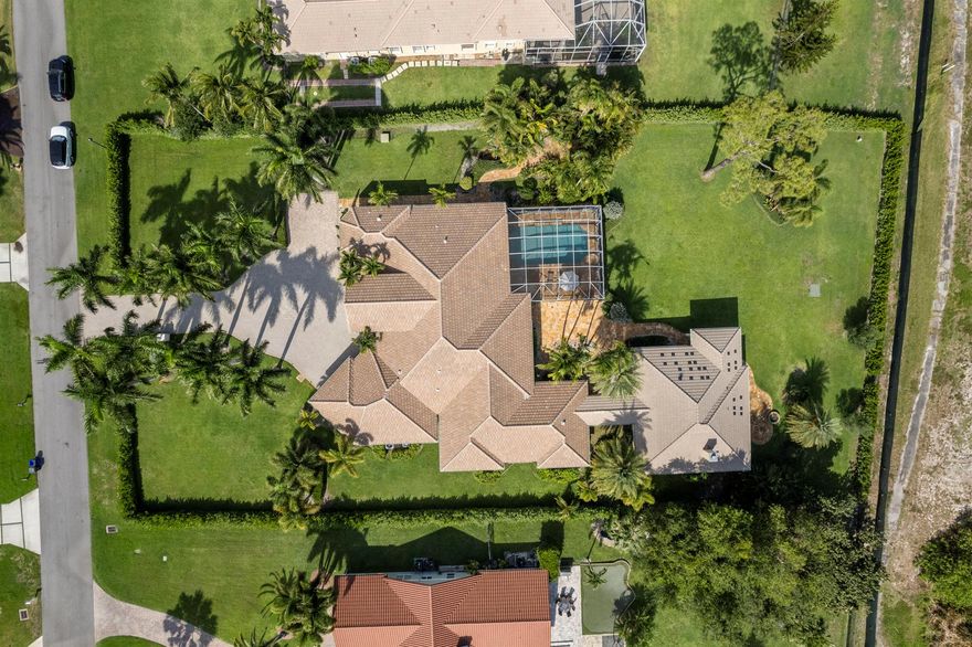 Seven bedrooms total, 5458 square feet on 1.04 acres with 5 Bedrooms and 5 full baths in the main house and a two-bedroom, 1 bath, guest house. High end appliances like Wolf and Sub-Zero, and finish details such as massive, solid wood entrance doors and superb theater room millwork, distinguish this home that was featured in Palm Beach's ''Simply the Best''. With a new roof, impact windows and commodious layout that afford great privacy, this home is a high value turnkey proposition.