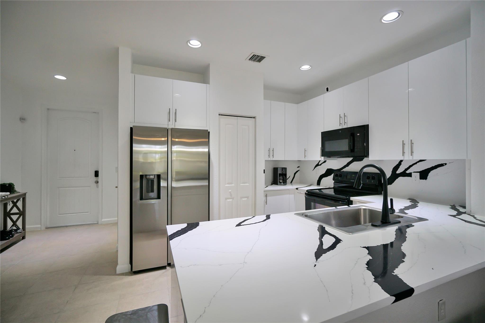 Offered FULLY-FURNISHED and Move-in-Ready! Built in 2017, this beautifully maintained & tastefully updated townhouse offers modern comfort & convenience in a prime location. Recently renovated kitchen features new white cabinetry, granite countertops, & a stainless steel fridge. Enjoy high ceilings & a spacious open-concept living area that flows seamlessly into a covered back patio—perfect for outdoor dining or grilling. Upstairs, you’ll find three generously sized bedrooms & an updated bathroom with a stylish new vanity. Additional features include hurricane shutters for added security, smart home technology, & an attached garage for parking & extra storage. Located just minutes from I-95 & the Sawgrass Expressway, with easy access to shops, schools, hospitals, & the Deerfield Beach Pier