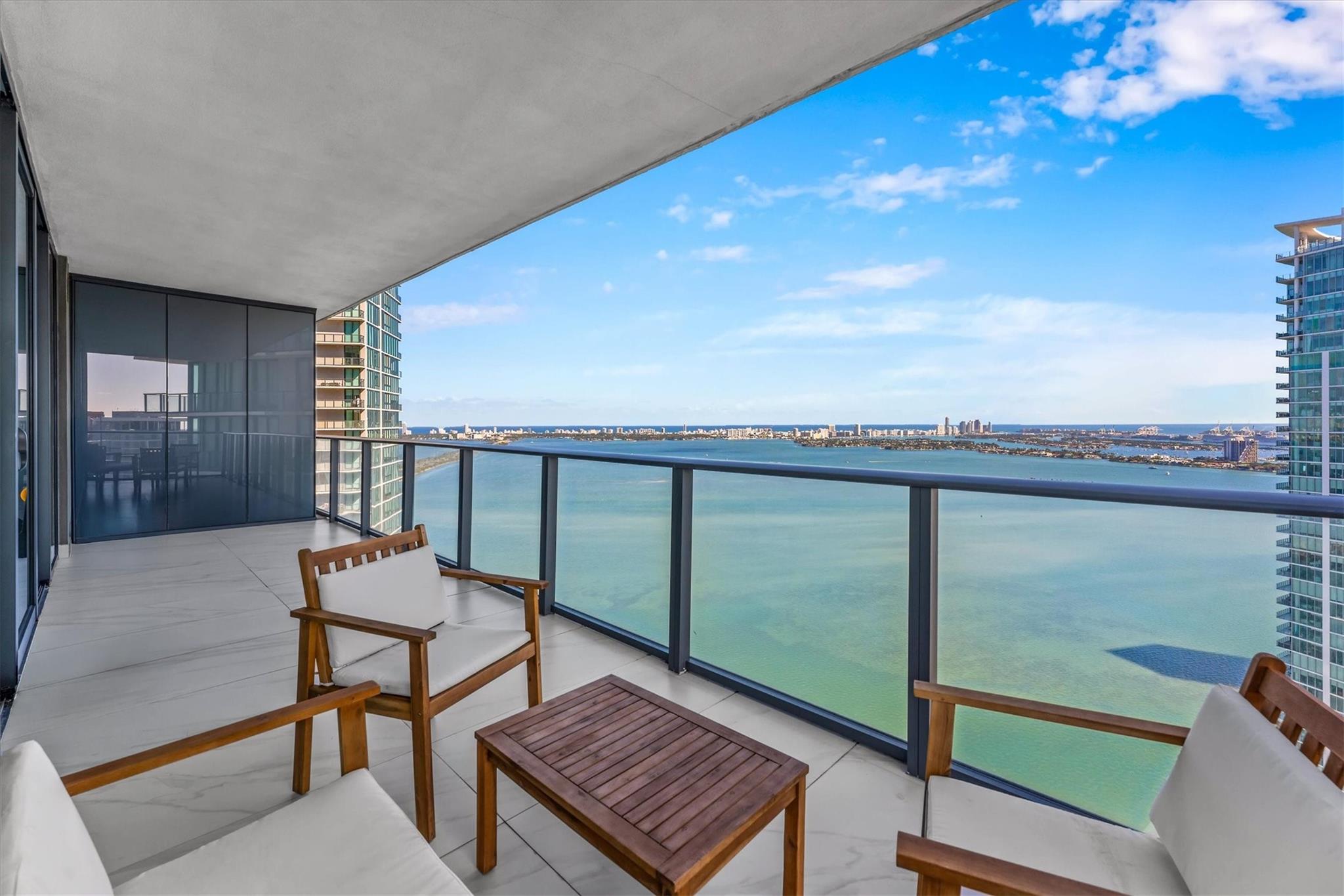 Don’t miss this rare opportunity to live in a luxurious 4-bedroom waterfront condo (unfurnished) on the 45th floor of a newer construction building with incredible amenities. Spanning nearly 2,000 sq ft, this flow-through home in the sky offers an open layout with glass floor-to-ceiling impact windows & doors that showcase breathtaking water & skyline views. The gourmet kitchen features high-end appliances & a spacious island. The primary suite boasts a spa-like bath and built-out walk-in closet, while three additional bedrooms provide flexibility for guests or a home office. Enjoy exclusive access to world-class amenities, including a resort-style pool, fitness center, wine cellar, tennis courts, spa, bowling alley, security and concierge. This is luxury waterfront living at its finest