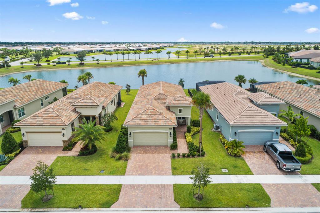 WAKE UP TO THIS SUNRISE VIEW...2 bed + Den + 2 bath Bella floorplan in PGA Verano located on a rare DOUBLE LAKE VIEW lots in the community. Upgrades inc: upgraded cabinets & quartz counters kitchen & baths, SS farm sink, plank tile floors throughout, quiet upgraded dishwasher, 5 burner range w/convection oven, decorative impact glass front door, screened lanai, epoxy garage floor. PGA Verano - 5 Star luxury community easy access to I-95. Adjacent to the renowned 54 hole PGA Golf Club w/Cart Path access. 40,000 sq ft clubhouse/fitness center. Amenities incl: Indoor Lap Pool, 5 Har-Tru Hydro Tennis Courts, 27 Pickleball Courts, Resistance Pool, 7000 sq ft E-Gym, bocce, card room, ballroom, demo kitchen, saunas, outdoor resort pool w/cabanas. Publix by the front gate.