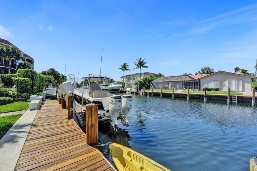 Stunning waterfront townhome with SE exposure in a boutique Boca Raton boating community of just 6 townhomes.  This beautifully updated townhome boasts a luxury gourmet kitchen designed for culinary mastery, 2 large ensuite water view bedrooms, floor to ceiling impact glass to maximize natural light and views of surrounding landscape and water, BOAT dockage for up to 32 foot (total length) boat directly behind your home, motorized blinds for effortless light control and privacy, community pool and lush landscaping.  (Boat lift has been removed)