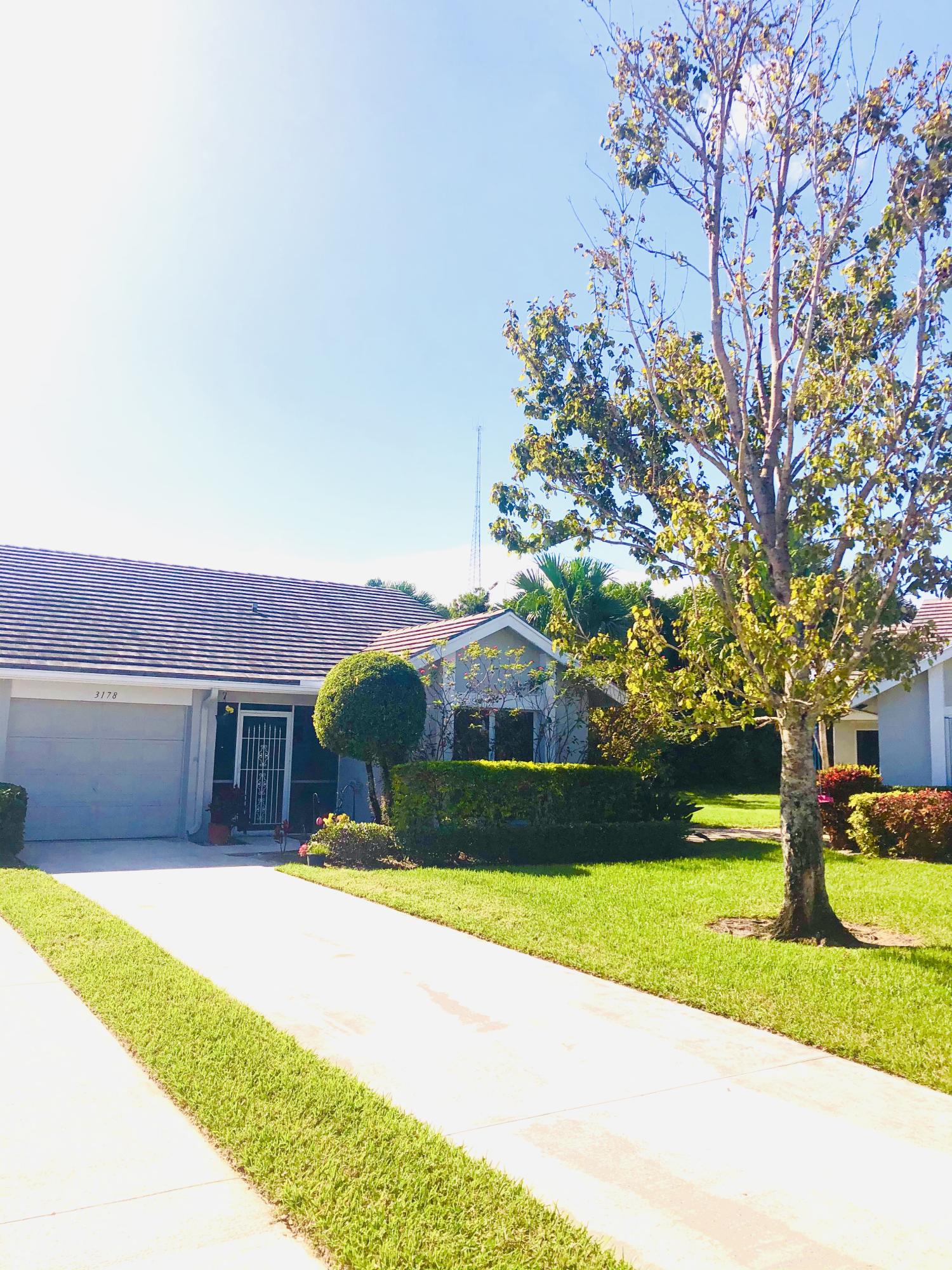 Gorgeous end unit villa 3 bed 2 bath Villa with 1 car garage all ages community in Sunset Trace. 2019 tile flooring installed throughout the home, Vaulted ceiling!Large green space in back with no other homes behind you. Small pond right outside your patio. lots of natural light and lots of privacy.Guard gated community w/ 2 community pools + racquet ball courts! Conveniently located close to Florida's Turnpike as well as shopping, restaurants and medical facilities. And only a 15 minute ride to the pristine waters of the Atlantic Ocean and the numerous waterways and boating facility