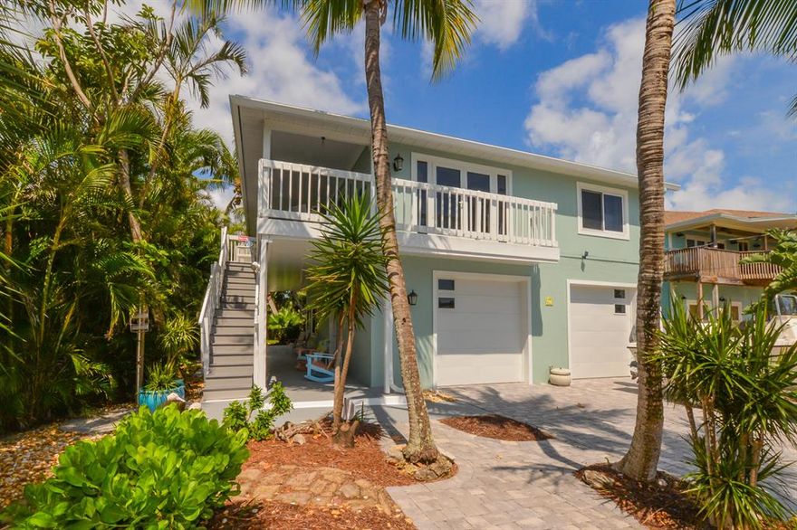 Great location! Just 2 blocks to the beach! Completely & beautifully renovated! Impact glass windows & french doors, new kitchen w/granite & stainless appliances, & gas range upstairs, newer A/C, new hurricane rated garage doors, gorgeous brick paver driveway and walkways! Freshly painted CBS 2-story w/ 2 separate livings areas, an open plan 2/2 upstairs w/ wraparound porch and a 1/1 garden apartment downstairs w/separate entrance & covered porch. Tropically landscaped with sprinkler system, outdoor shower, & a privacy fenced backyard!  Beautifully furnished, (a few exclusions) move in ready! Relax and enjoy the tropical ocean breezes! Best beach house on the island!