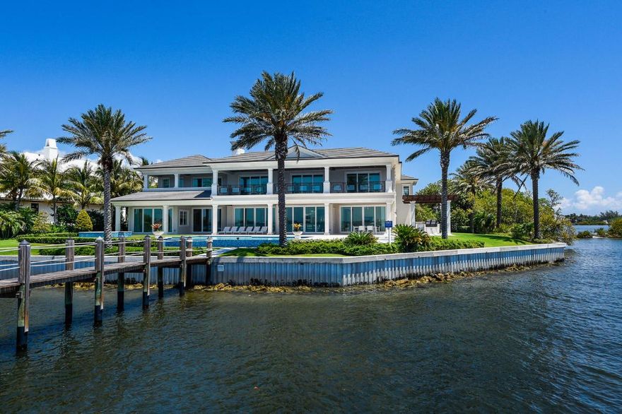 Stunning, brand new estate surrounded by the Intracoastal on point lot. Transitional estate with over 9,700 total square feet features boat dock, 6 bedrooms, 8 full baths, and powder room. Five car garage, library, elevator, & gym. Gorgeous outdoor spaces include balconies, covered and open patios, spa, and infinity pool with amazing water views. Built by Farrell Building Company.