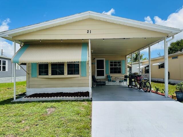 Welcome to this beautifully furnished turnkey home featuring an updated kitchen & bathrooms - w/ new laminate flooring throughout. Well maintained 2 bed/2 bathroom offers privacy & functionality; perfect for entertaining guests or those seeking a tropical retreat. The kitchen boasts ample counter space & the living areas are spacious w/ a large Florida room extending into a screened in cafe patio. Indoor laundry room is conveniently equipped w/ an additional sink. Overall this property is in a prime location; close to the beach, grocery stores, shopping, post office, banks, hospitals & more. Land lease of 753.08 covers taxes, lawn care, trash, include boat ramp w/ dockage, heated pool, shuffle board, tennis, pickleball, ping pong, bocce, billiards, community room, library & more!
