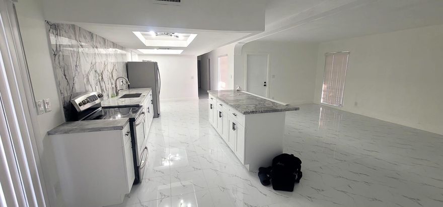 **A must see***Stunning  fully remodeled one-story home with a very open and modern floor plan. This spacious property features 4 bedrooms and 2 updated bathrooms, a large family room, and a bright Florida room that offers plenty of space for relaxing, entertaining, or a play area.The brand-new kitchen includes modern cabinets, granite countertops, and stainless steel appliances, all overlooking the main living area. The home also features fresh interior paint and a NEW ROOF making it truly move-in ready.The garage has been converted into a 4th bedroom, perfect for guests, or extra family space. Enjoy the huge backyard, ideal for kids to play, pets, entertaining, and outdoor gatherings.Located in a great neighborhood, good schools nearby, and a  wonderful place for families.