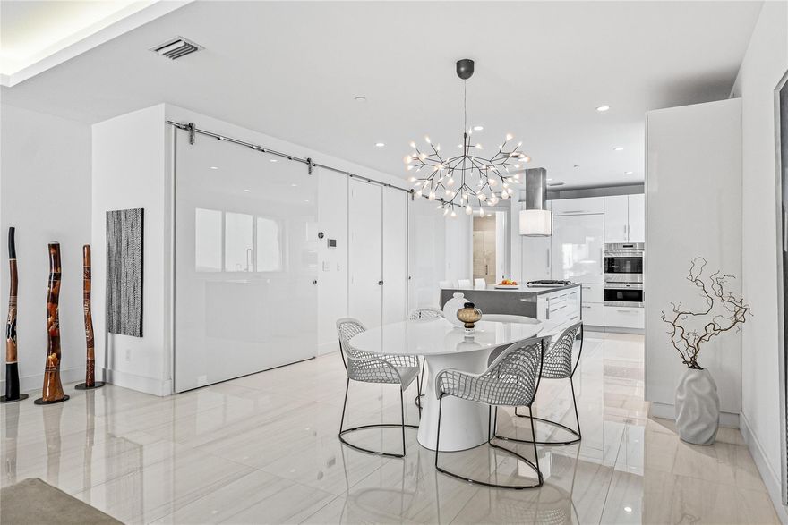 Coastal charm meets elevated elegance at this four-level, modern townhouse in the beach town of Lauderdale-by-the-Sea. With 3 spacious bedrooms and 3.5 baths, this like-new residence offers stylish living across three interior levels, plus a private rooftop terrace with 360° views. The ground floor features a 2-car garage with custom storage, entry courtyard, and en-suite bedroom/office. A floating staircase leads to a designer kitchen, pantry, laundry, spacious living area, terrace, powder room, and second bedroom with full bath. The third-floor primary suite stuns with dual walk-ins, soaking tub, and luxe shower. Private elevator, community pool, hydro-spa, and boat slips (as available). Walk to beach, dining, shops. Unmatched value.
