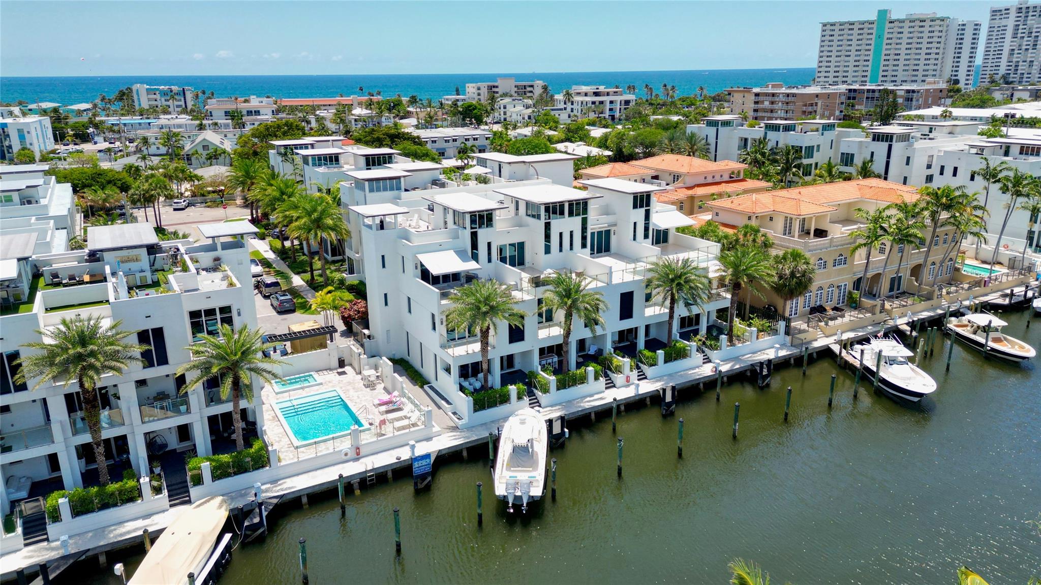 Coastal charm meets elevated elegance at this four-level, modern townhouse in the beach town of Lauderdale-by-the-Sea. With 3 spacious bedrooms and 3.5 baths, this like-new residence offers stylish living across three interior levels, plus a private rooftop terrace with 360° views. The ground floor features a 2-car garage with custom storage, entry courtyard, and en-suite bedroom/office. A floating staircase leads to a designer kitchen, pantry, laundry, spacious living area, terrace, powder room, and second bedroom with full bath. The third-floor primary suite stuns with dual walk-ins, soaking tub, and luxe shower. Private elevator, community pool, hydro-spa, and boat slips (as available). Walk to beach, dining, shops. Unmatched value.