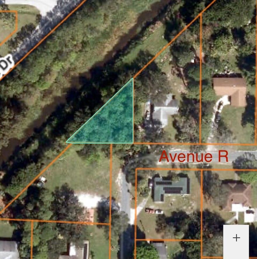 Build your dream home on this one of a kind triangular lot that backs up into a canal and cleared land on one side. Located just seconds from new built high school to be completed by January 2026 and now A rated school district. Minutes away from Interstate Highway and growing downtown. Become part of many projects coming to Fort Pierce. City water and low county taxes.