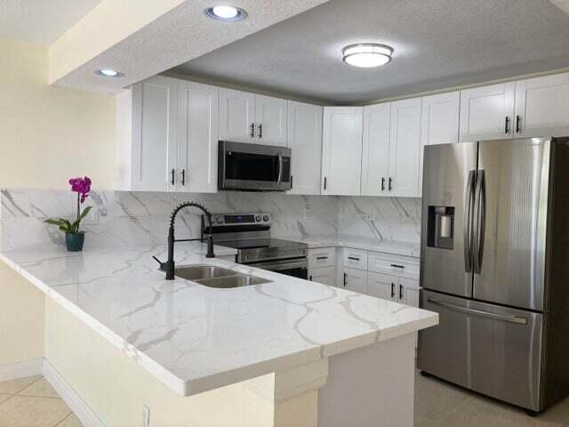 Newly Renovated & Extremely Spacious Lakefront 3BR/2.5Bath Townhome Plus in a Friendly Family oriented community. This property boasts a private entry Courtyard, Updated kitchen with new Appliances, Formal Dining & Family room, separate Laundry facilities on 2nd floor, Tiled/Laminate floors, new Accordion Hurricane Shutters. Enjoy your morning coffee while watching wildlife on your picturesque lake. Community has Pool, Tennis Courts, Jog/Bike Trail, Tot-Lot & newer Clubhouse. Close proximity to Turnpike, 1-95, Town Center Mall, Shops & Restaurants. Walk to A-Rated Elementary school. This Townhouse is Awesome-A RARE FIND! ''Call Today for a Happy Tomorrow''
