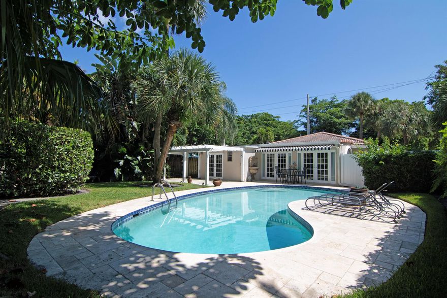Charming bungalow on a coveted corner lot in the exclusive El Cid neighborhood of West Palm Beach. Just one block on a tree lined street to Flagler Drive and the Intracoastal waterway. Open concept, high ceilings and many windows provides tons of natural light. Newer AC and hot water, plantation shutters;  French doors to the large pool surrounded by meticulous lush landscaping and high clusia hedges is both serene & very private. On a 9070 SF +/- lot, this home is  non-contributing which means you have many options here! Move in, add on, or build new!