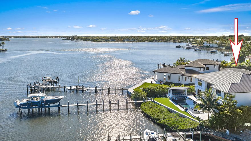 Waterfront estate home built in 2022, ideally positioned on a quiet street with fewer than ten homes and offering some of the most impressive views Jupiter has to offer. Designed with sleek, modern architecture, the residence is complemented by a separate guest house, providing flexibility for visitors, extended family, or a private office. Enjoy true waterfront living with a 50,000-lb boat lift and direct ocean access right from the backyard. Perfectly situated near Jupiter's iconic sandbars, waterfront restaurants, and everything the area's famous waterways have to offer. The outdoor living space is designed for year-round enjoyment, featuring a resort-style pool and spa, expansive turf areas, multiple fire pits, and an exceptional summer kitchen with a gazebo—creating the ideal setting for entertaining or relaxing in complete privacy. Seamless indoor-outdoor flow enhances both functionality and livability throughout the home. The primary suite will blow your mind, featuring expansive custom closet space, sweeping views looking the full length of the river, and an incredible primary bathroom that completes the experience. A rare opportunity to own a newer construction waterfront estate offering privacy, modern design, breathtaking views, and immediate access to the Jupiter lifestyle.
