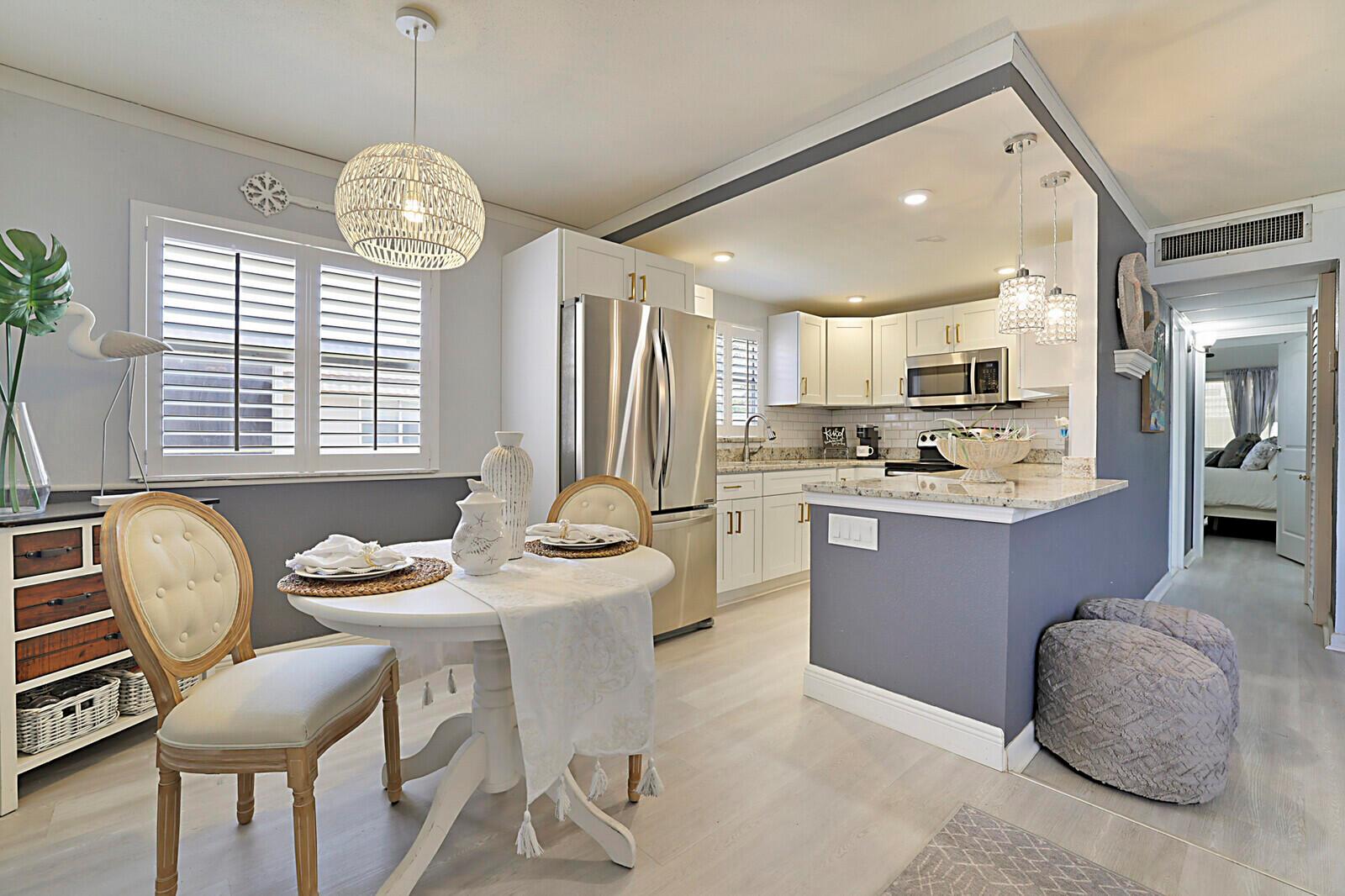 Coastal charm meets carefree living in this fully updated 2BR/2BA second-floor condo in Kings Point! Featuring a new kitchen with granite counters, open-concept design with counter seating, renovated bathrooms, and wood laminate flooring throughout. Plantation shutters add a touch of elegance. Light, bright & move-in ready! Enjoy resort-style 55+ amenities: indoor & outdoor pools, tennis, pickleball, golf, theater, salon, barber, fitness center, shuttle & more. Ideal for year-round or seasonal living!
