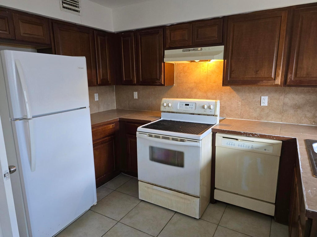 Photo of 4511 Treehouse Lane #E, Tamarac, FL 33319 (MLS # B26094198)