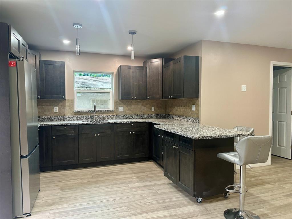 ALL UTILITIES included! Beautifully updated 2BR/2BA apartment in Davie with private gated side entry, located in a separate building behind the main home. This 985 sq ft unit features a modern kitchen with granite counters, stainless steel appliances, built-in closet systems, wood-look tile flooring, updated bathrooms, and impact windows and doors. Enjoy your own private side yard and access to an on-site laundry room. Pet friendly. Prime location near major highways, shopping, and dining. Private, quiet, and move-in ready!
