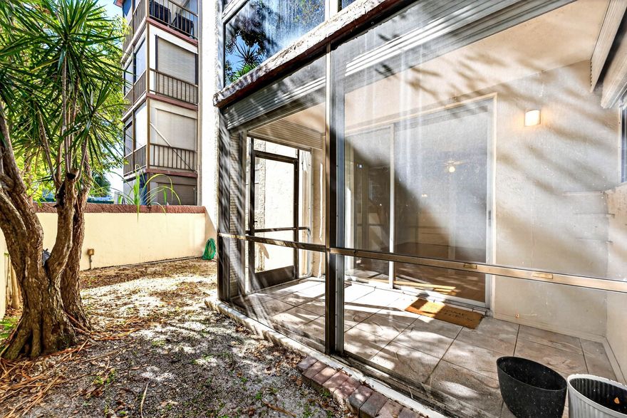 Bright, sunny 1 Bedroom, 1.5 Bathroom first floor End Unit condo with screened-in porch with an exit to your own private yard with a walled-in courtyard for your gardening or entertaining needs.  Unit is just steps to the community laundry room for convenience.  All ages community, no pets.  Secure entrance to condo hallway through lobby.  Omega 1 Condo is close to many schools, restaurants and shopping, centrally located in Plantation Florida.  Community amenities include clubhouse, pool, gym, racquet courts.