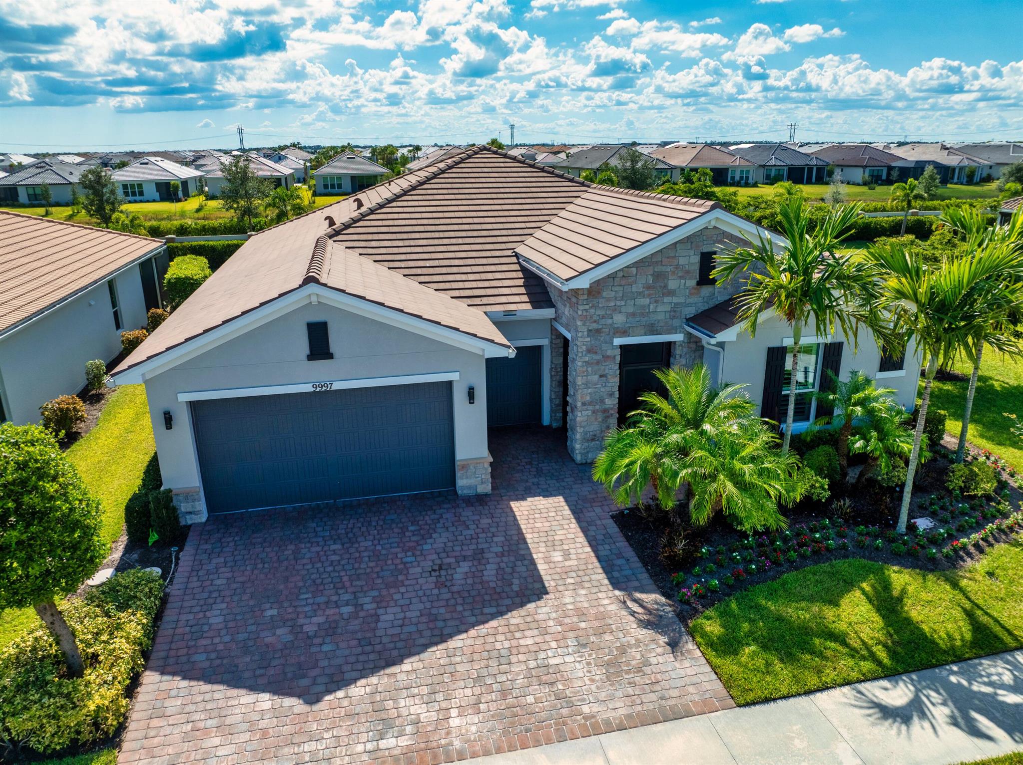 This beautifully upgraded 3-bedroom, 2.5-bath pool home with a den offers 2,446 square feet of elegant living space and includes a fully extended garage plus a golf cart garage. From the moment you enter, you'll appreciate the high-end finishes, including plantation shutters, stunning tile flooring, tray ceilings, crown molding, and impact windows, all under a durable tile roof. The spacious open-concept family room flows seamlessly into a gourmet kitchen featuring a large center island, dual wall ovens, a gas cooktop, and plenty of cabinetry--ideal for entertaining and daily living. The oversized master suite is a true retreat, complete with dual walk-in closets, his-and-her sinks, and a luxurious walk in shower.