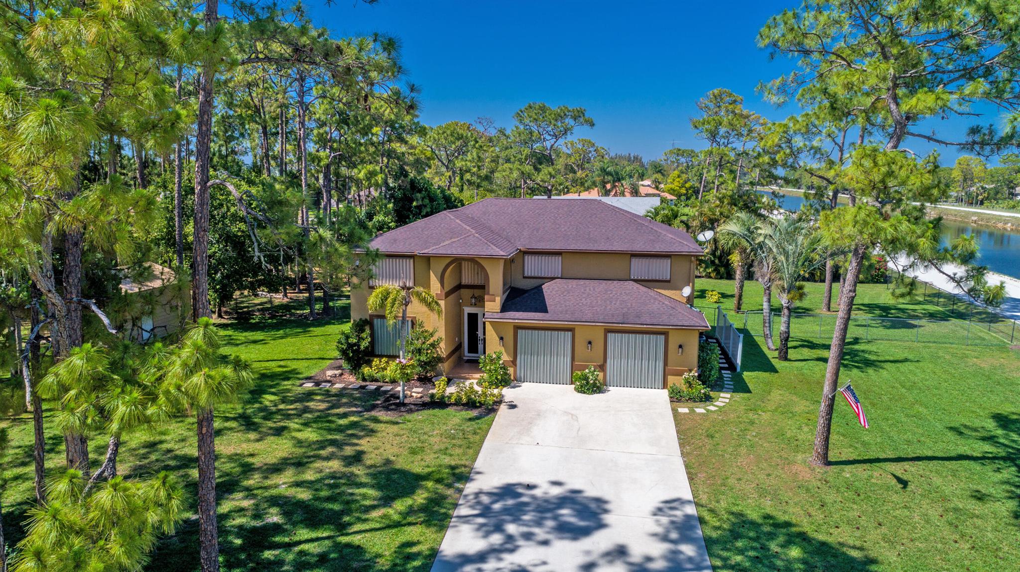 Beautifully maintained 4 br 3 bath 2 story house with pool on large lot (2+ acres). Backyard is an oasis. Fully fenced yard with electric entrance gate. Roof was replaced in 2018. Mango trees in yard along with other lush landscaping. Get the country feel while having the convenience of the city within a 10-minute drive. Picture with windows is edited