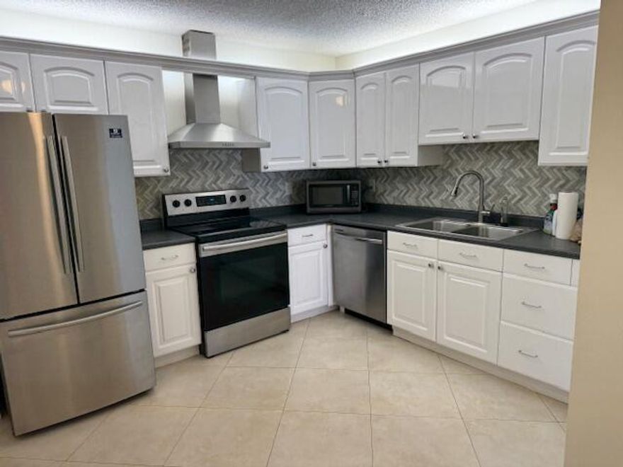 UNUSUALLY LARGE 2 BEDROOM 2 BATH WITH A DEN/DINING ROOM, FULL WASHER /DRYER AND ENCLOSED PATIO CORNER UNIT! UNIT HAS BEEN UPDATED AND IS IN EXCELLENT CONDITION WITH NEW ENGINEERED FLOORING. A GATED COMMUNITY WITH A CLUBHOUSE, TENNIS AND A LESS THAN 1 MINUTE WALK TO THE POOL. THE RENT INCLUDES WATER AND CABLE. BOCA RIDGE IS LOCATED 2 MINUTES FROM THE ALL NEW AND POPULAR ''UPTOWN BOCA PLAZA'', AND JUST 9 MINUTES TO THE BEACH. JUST 5 MINUTES TO THE TURNPIKE, CLOSE TO THE TOWN CENTER MALL, PUBLIX, HOME DEPOT/LOWES, BEST BUY AND YOU COULD NOT ASK FOR A MORE CONVENIENT LOCATION AT AN AFFORDABLE RENTAL.