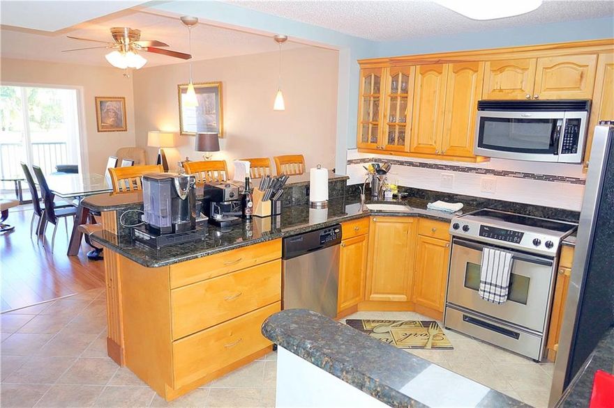 ONE OF A KIND! Rarely available RENOVATED Condo CORNER, largest 1 Bedroom, 2 FULL Bathrooms with splendid wide OPEN kitchen* Peaceful and beautiful garden views from enclosed patio with amazing floor to ceiling IMPACT HURRICANE WINDOWS facing east for morning sun* NICELY partially FURNISHED and negotiable Tempur-Pedic king size bed* 2nd renovated FULL bath with tiled shower, extra storage and a pocket door* Impeccable Kitchen has an extra long granite countertop, SS appliances, tiled backsplash and under cabinet lights* Low maintenance fees of $311/month includes Water, Cable, Building insurance and amenities. Conveniently located just EAST of I-95, only 5 minutes drive to the beach* ACTIVE 55+ community has 2 clubhouses, 2 heated pools & everything you need to enjoy the Florida lifestyle!