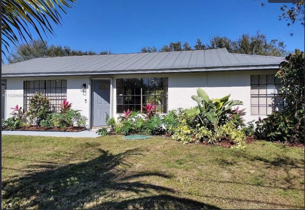 Photo of 841 NW Riverside Drive, Port Saint Lucie, FL 34983 (MLS # R11162783)